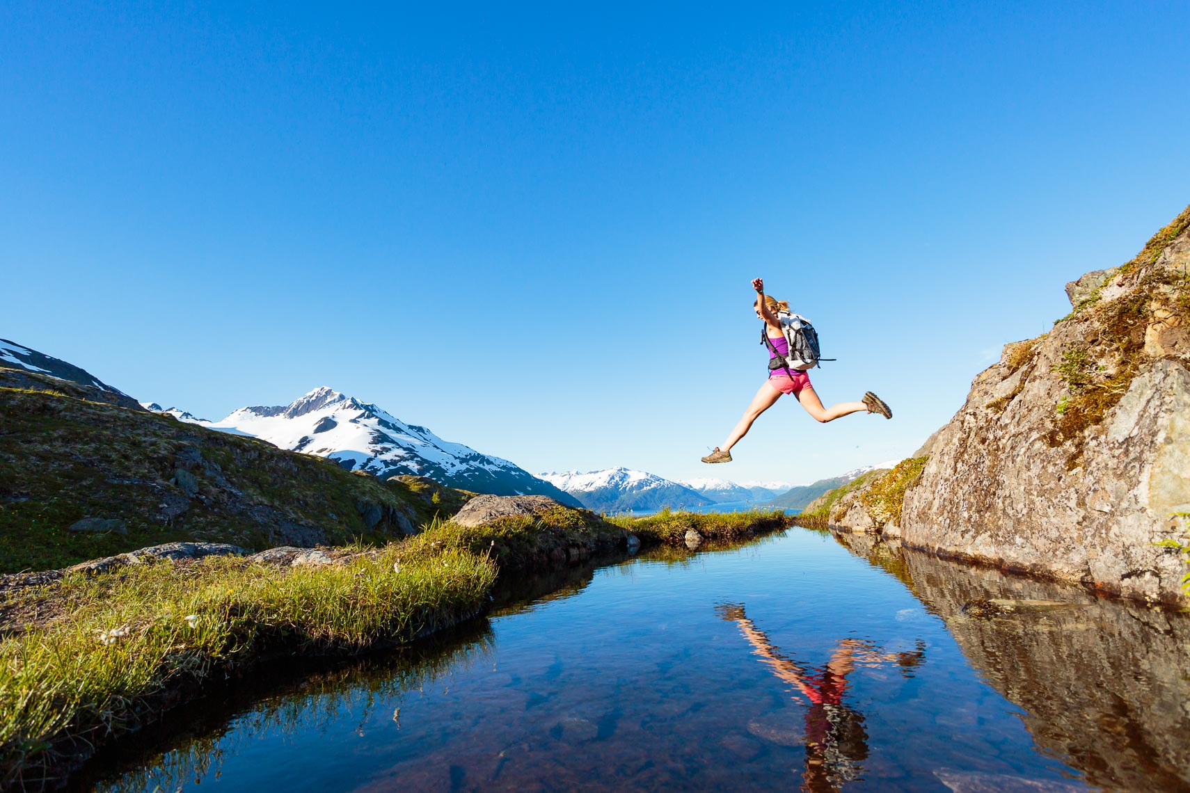 Woman Leaping Alaska Day Hike | Michael DeYoung