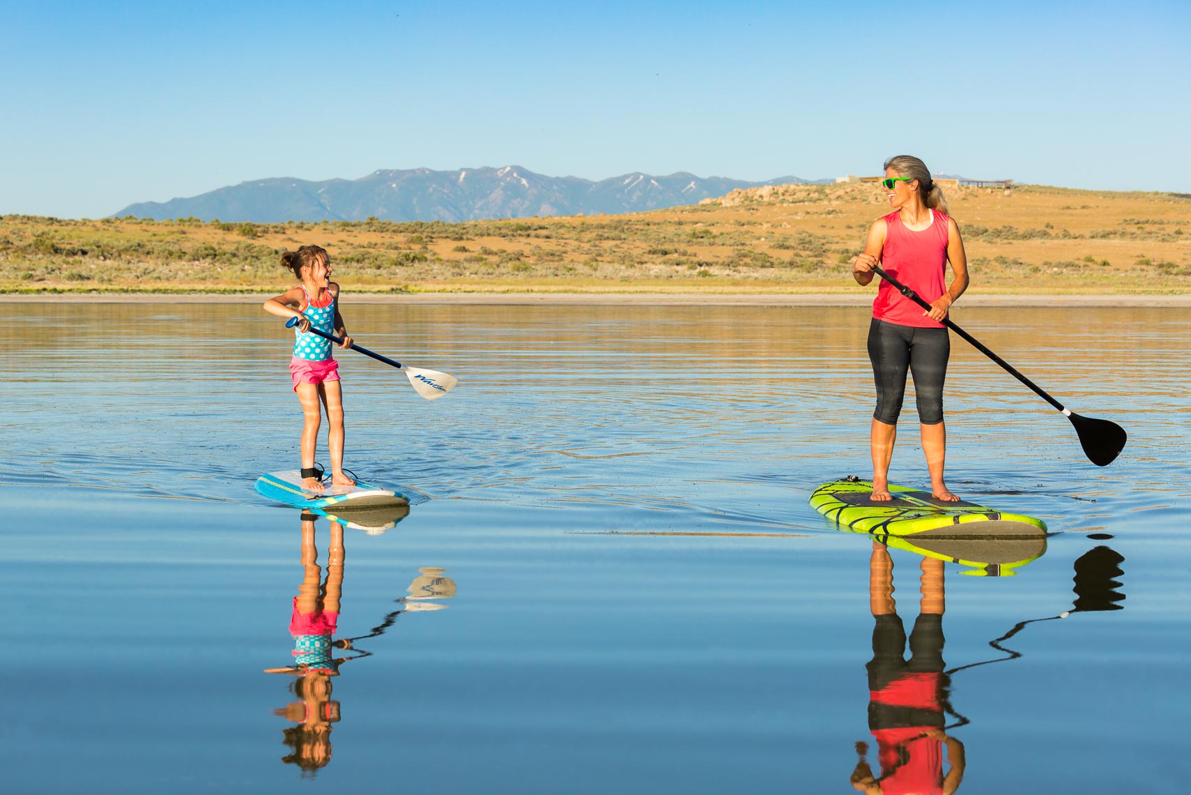 Woman and Child Paddle Boarding | Michael DeYoung