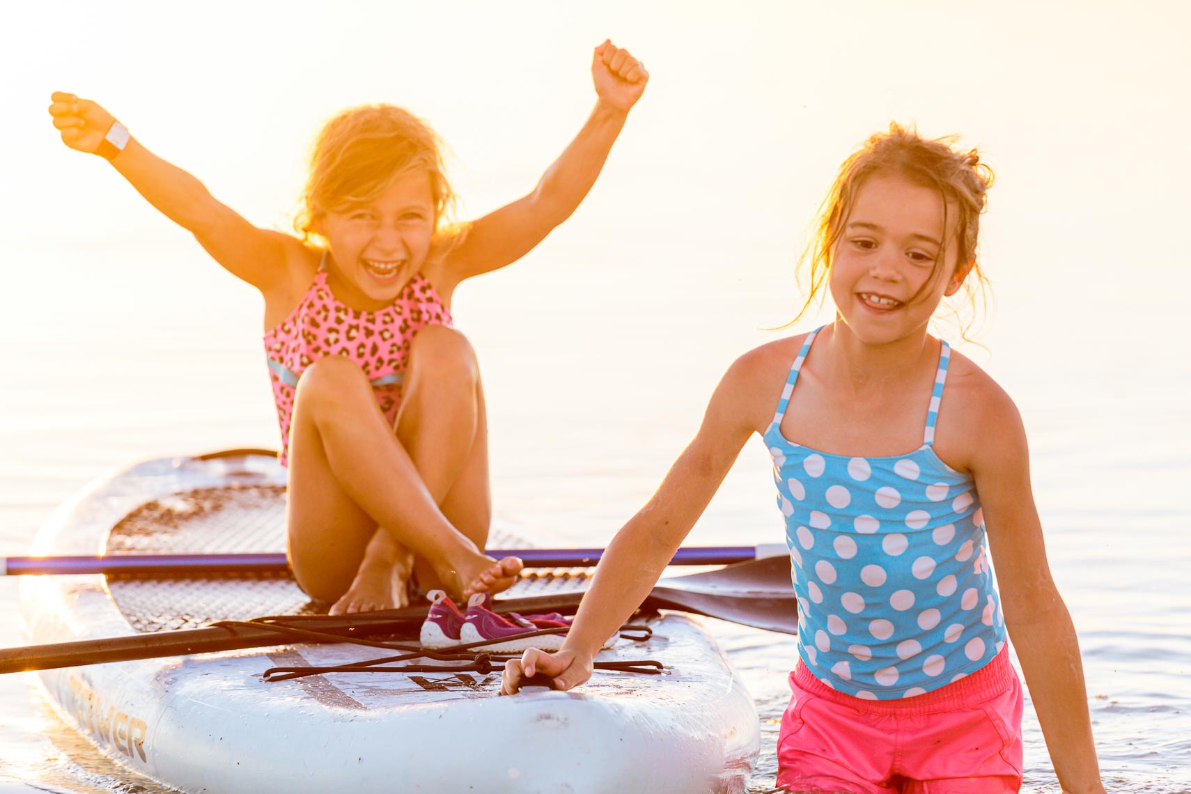 Joyful Young Girls on Paddle Board | Michael DeYoung
